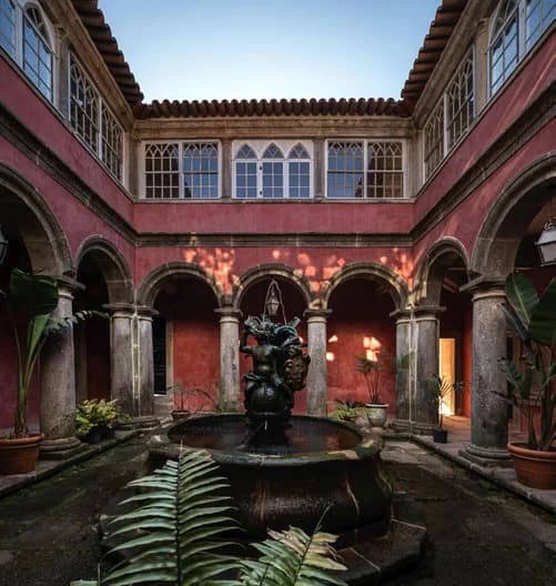 The cloister today, its arcades and fountain returned to quiet order