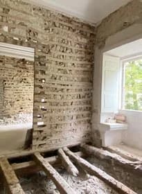 The groin vault during the works, its ribs bare behind protective netting