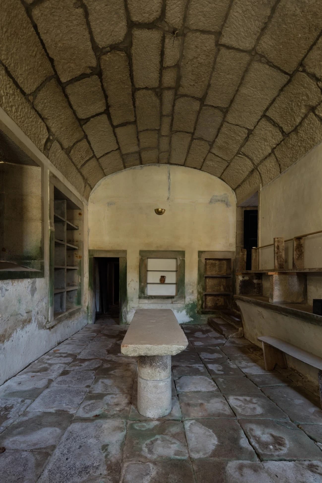 The restored vaulted hall today, stone floor and table returned to quiet order