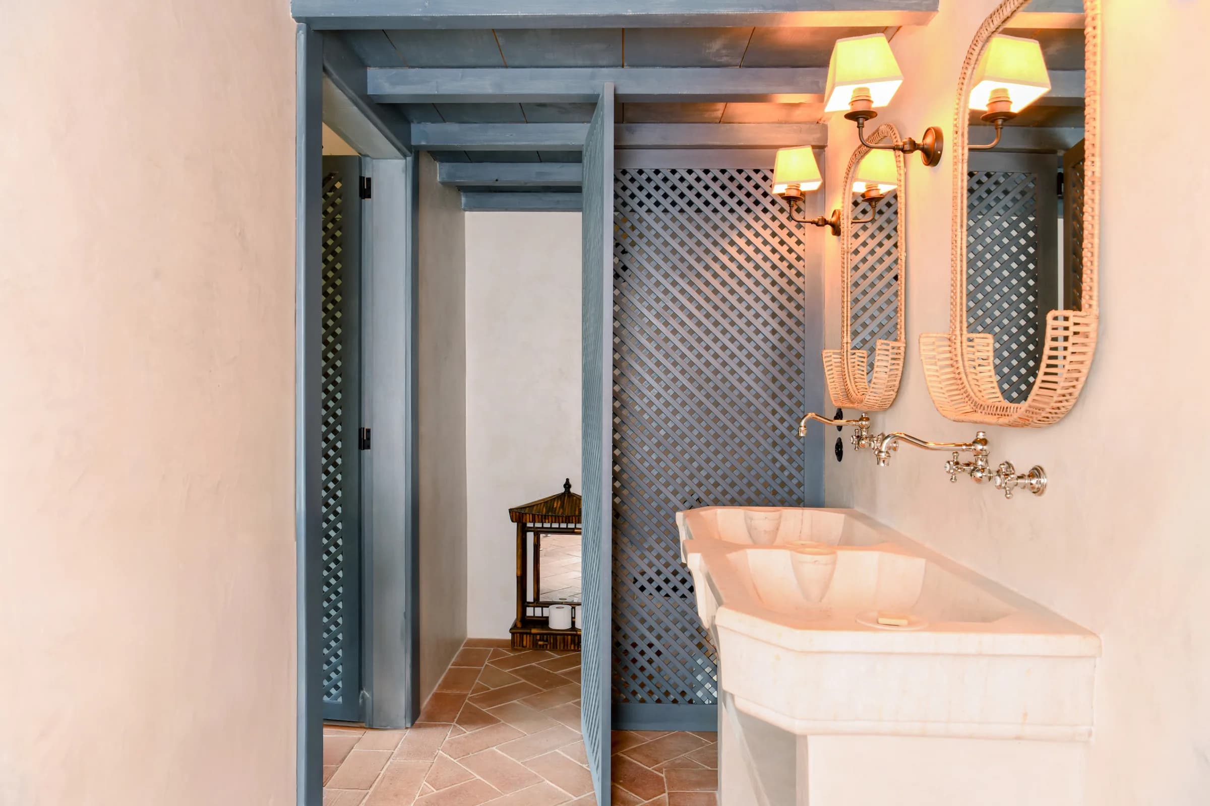 The Azalee bathroom — a wall niche with a stone washstand behind lattice screens