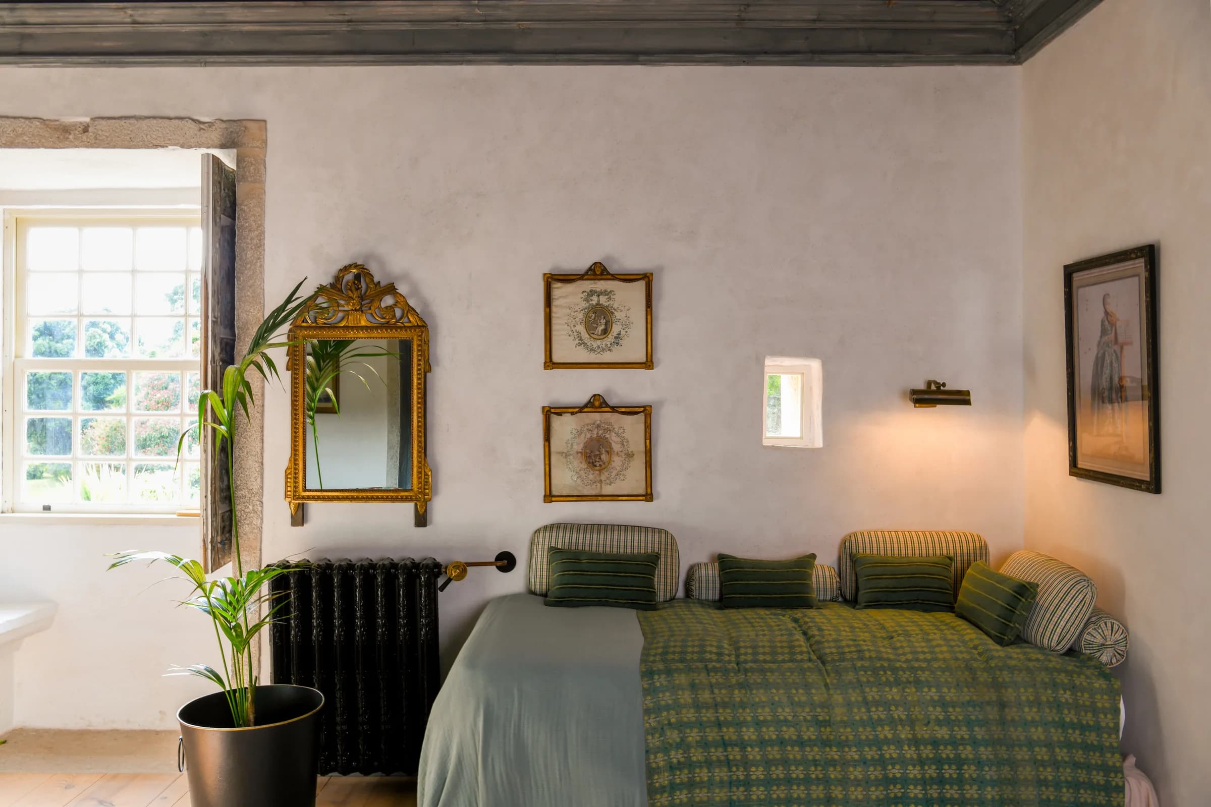 The Camelia suite — the sofa corner beneath a gilt oval mirror