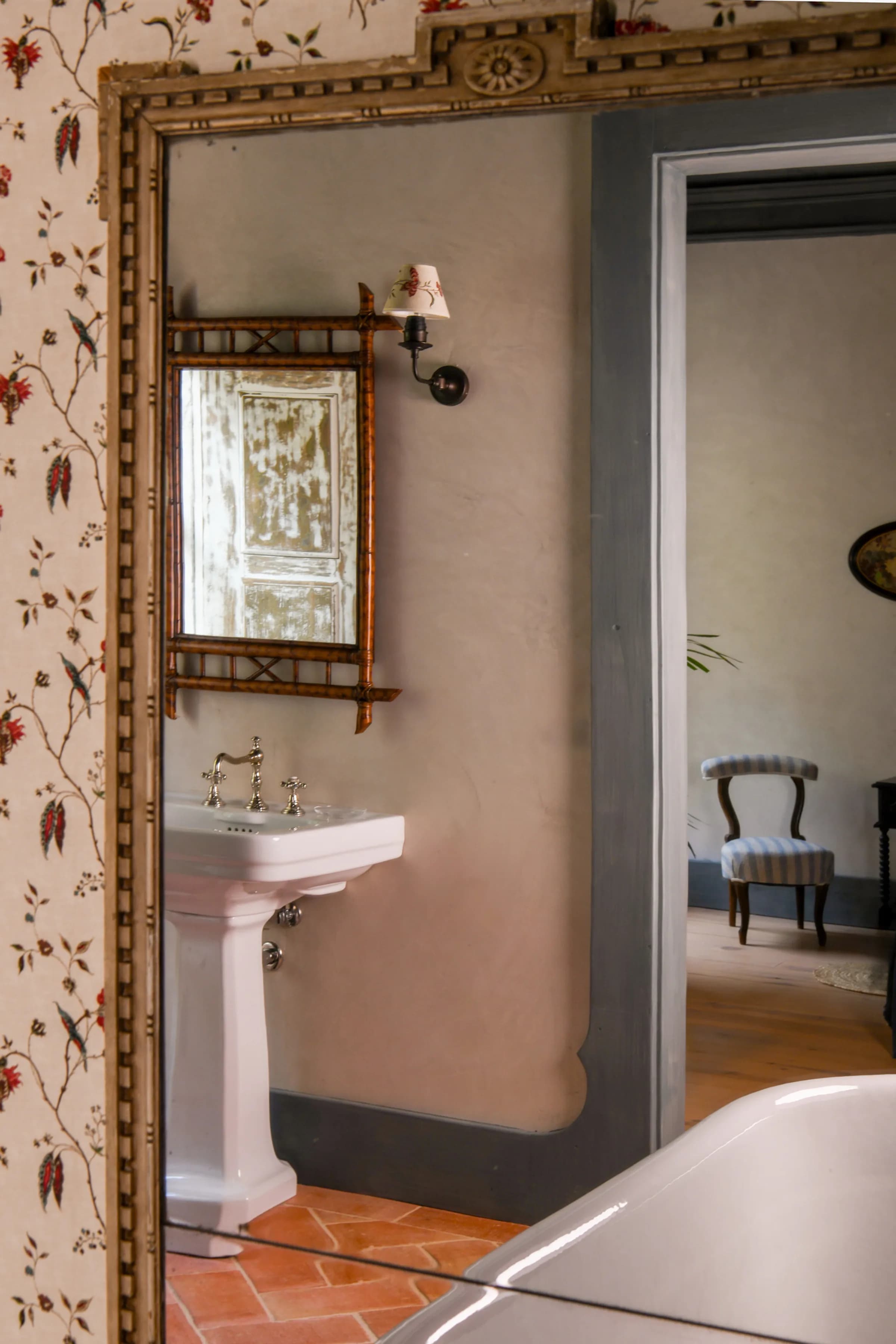 The Lilas suite — an antique gilt-framed mirror in the corridor