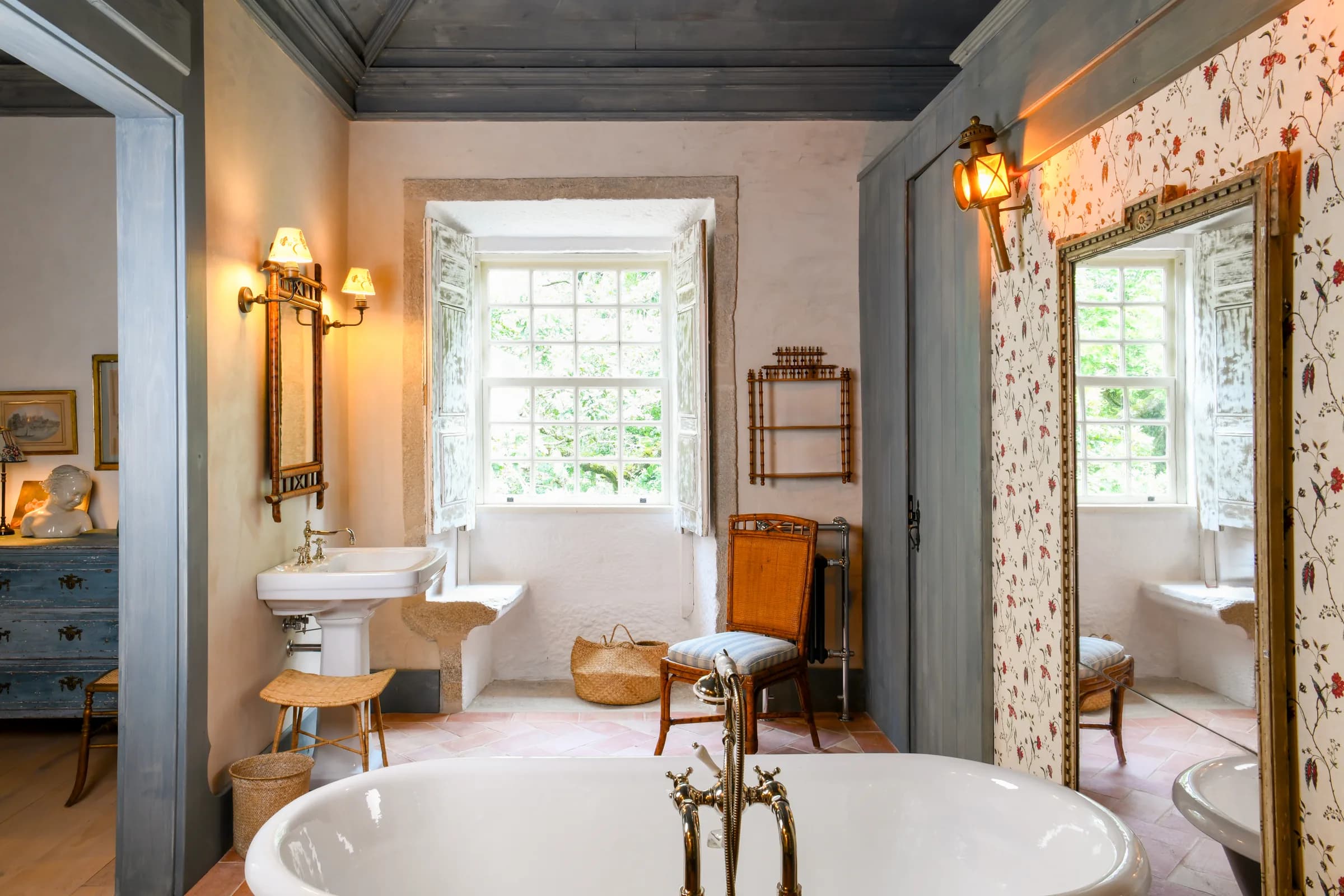 The Lilas bathroom — a freestanding tub before the tall mirror