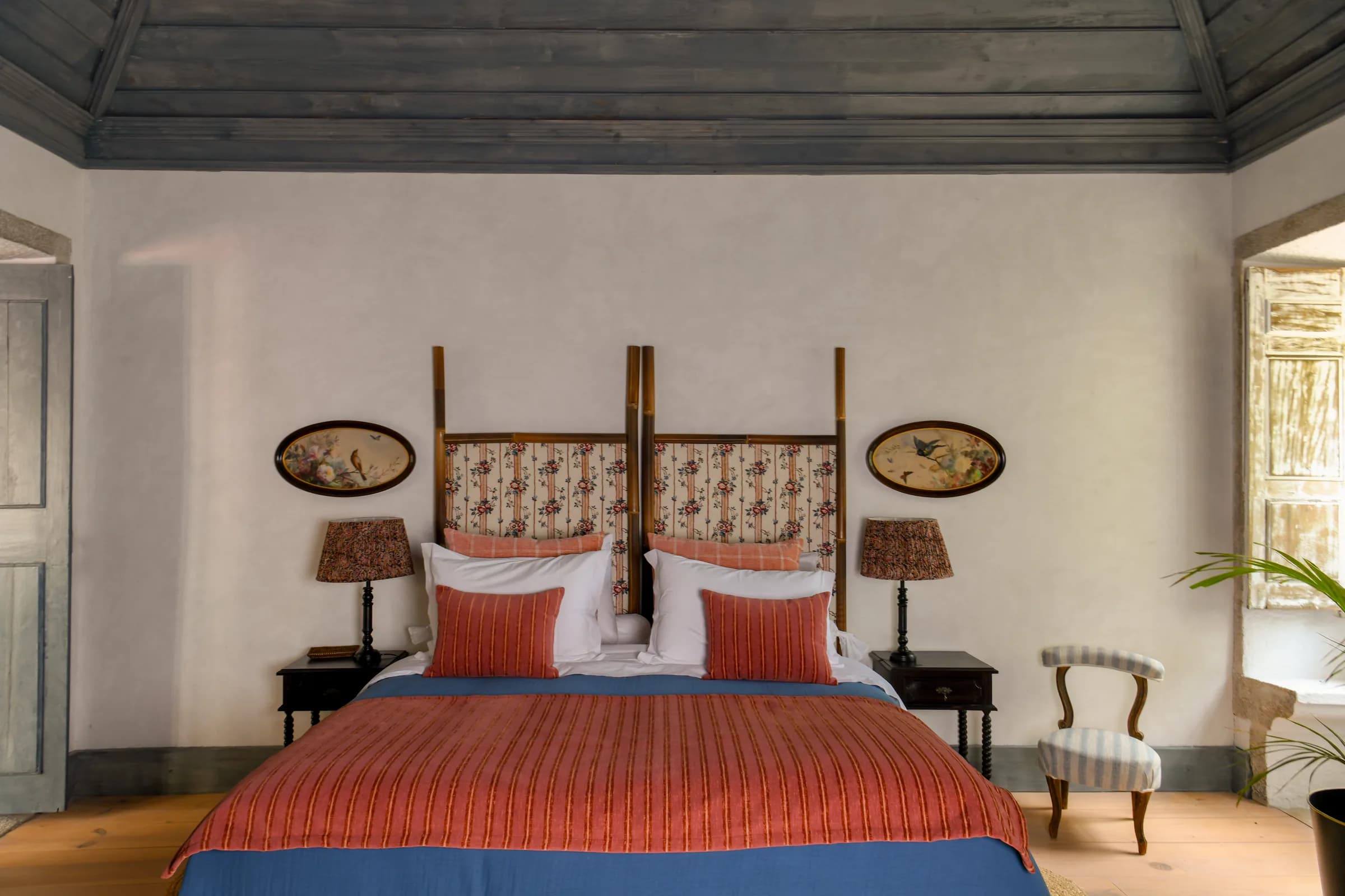 The Lilas suite — the four-poster bed beneath oval botanical prints