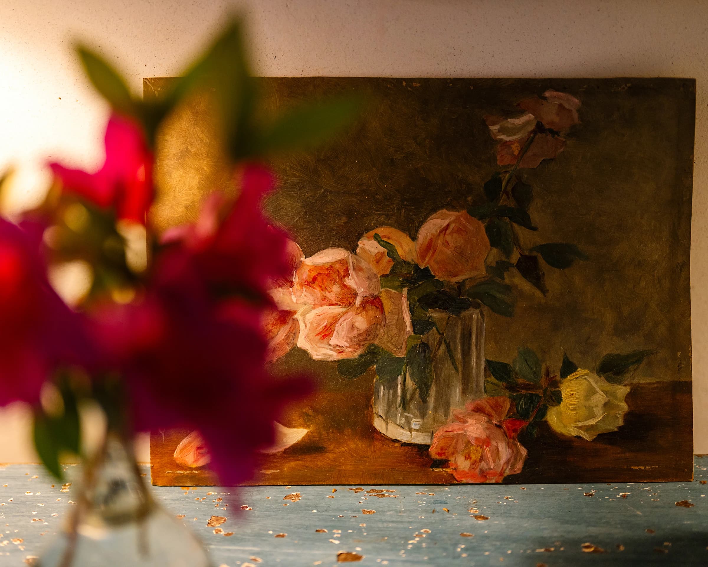 The Lilas suite — a rose still-life painting on the dresser, fresh roses in the foreground