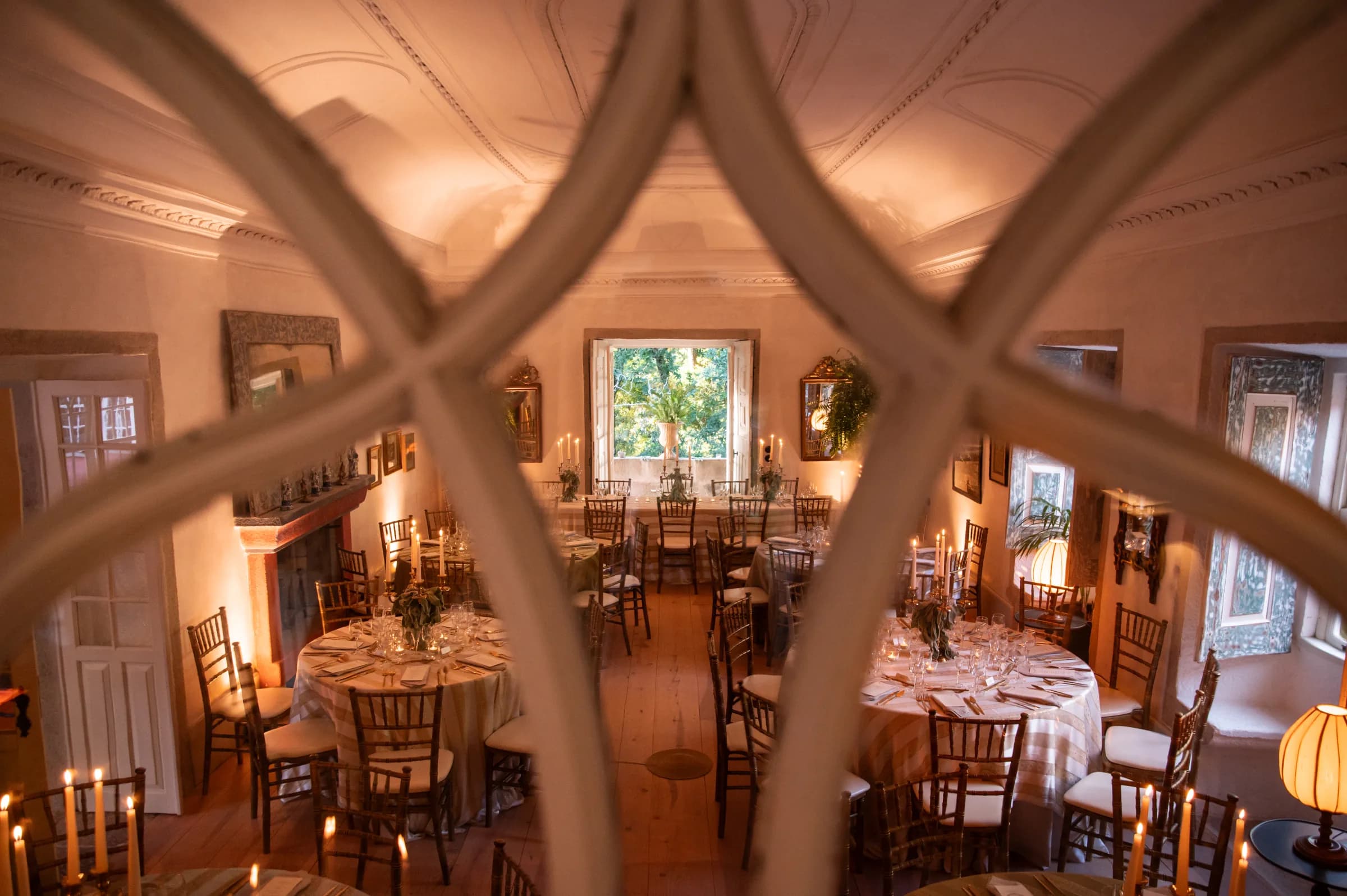 The salon, seating arranged before its fireplace and terrace doors