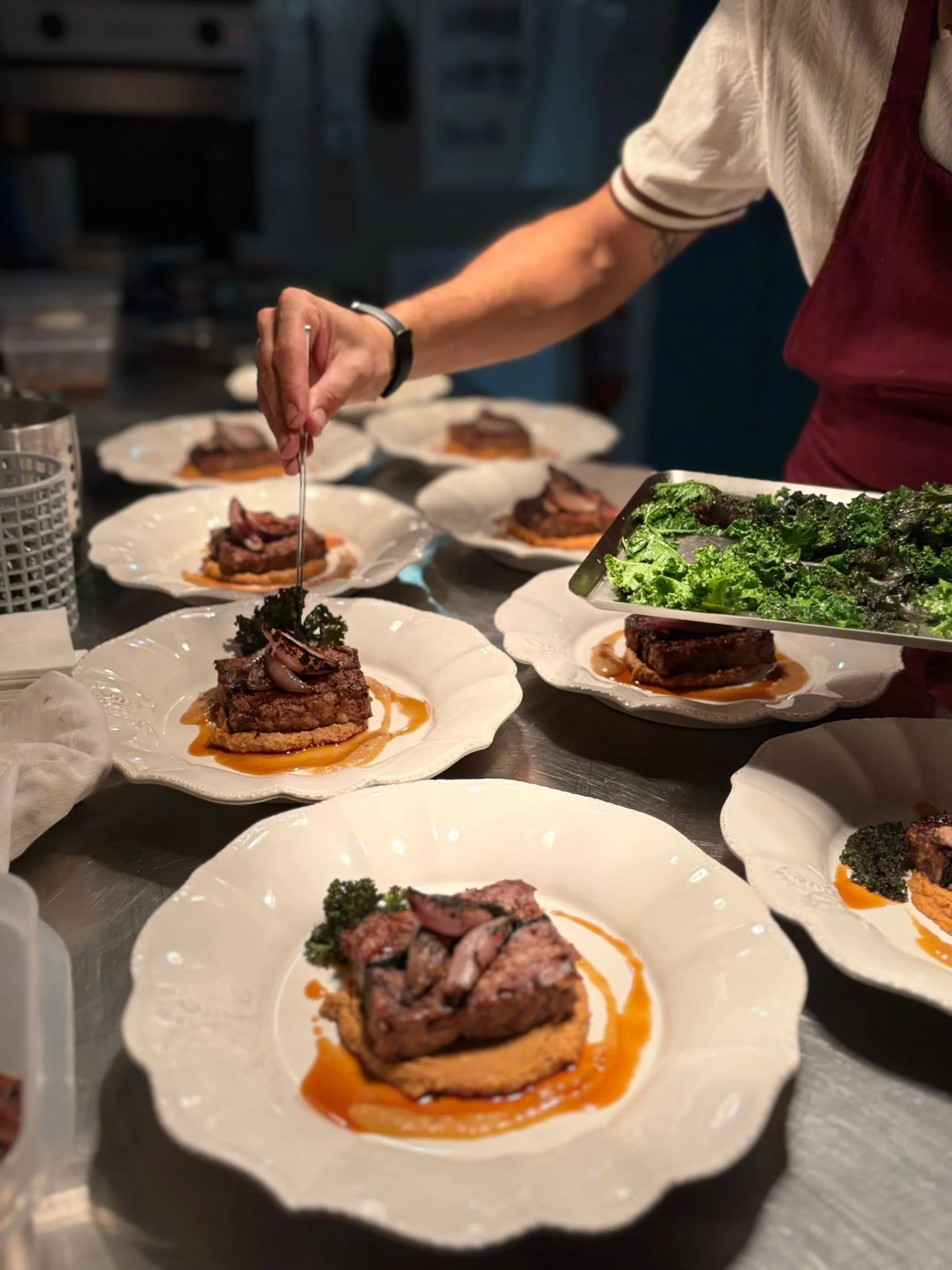 A monastery-style cookery class, hands shaping dough at a rustic table