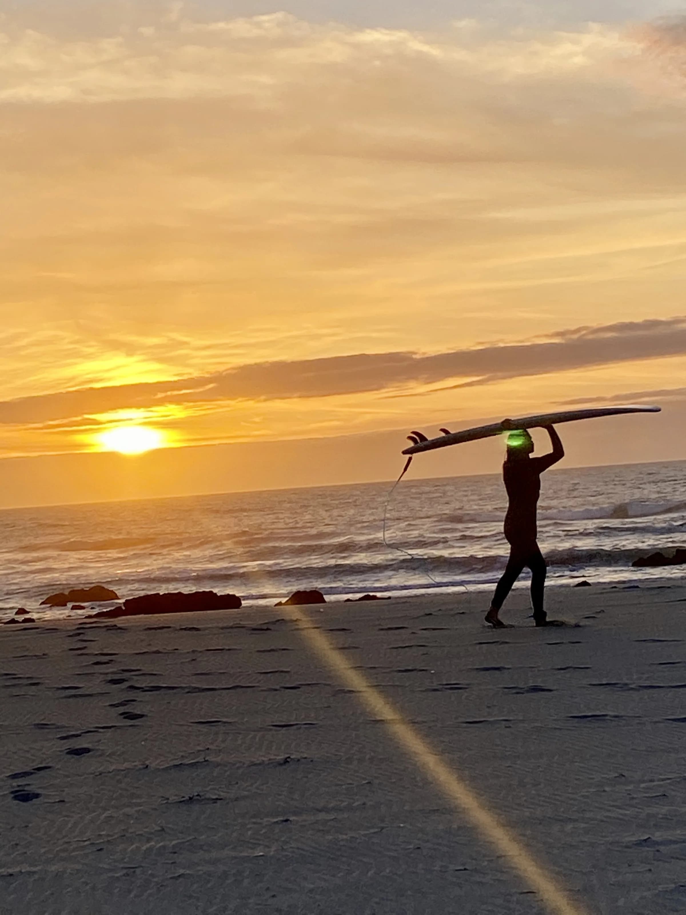 A surfer on the wild Atlantic coast near the estate