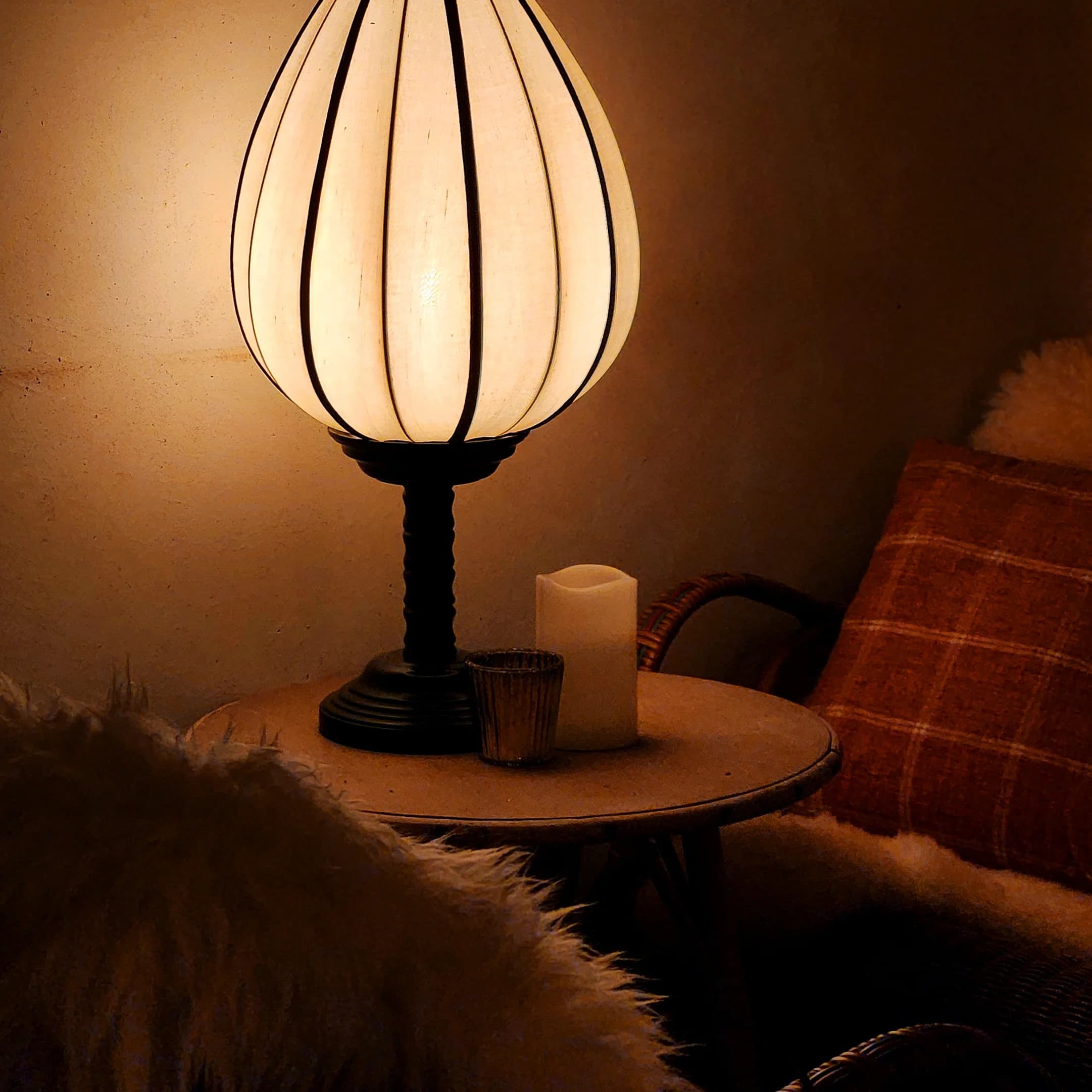 A lantern-shaded lamp glowing beside the fireside seating